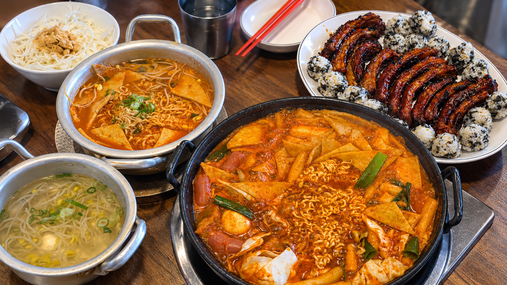 Spicy Korean food with grilled pork and rice balls at Ppalganjip in Jeju