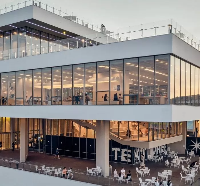 Modern ocean-view cafe in Busan with large windows and outdoor terrace
