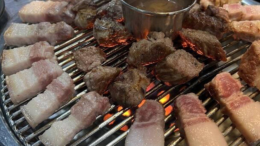 Jeju black pork grilling on a Korean BBQ grill